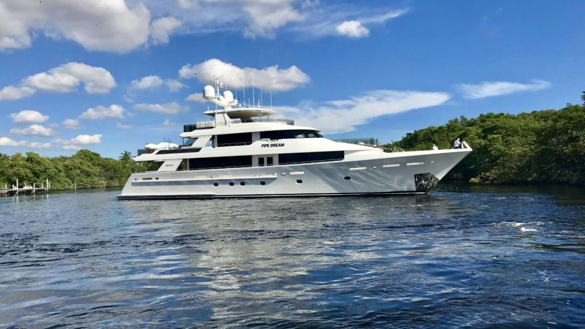 a white yacht in the water aboard PIPE DREAM Yacht for Sale