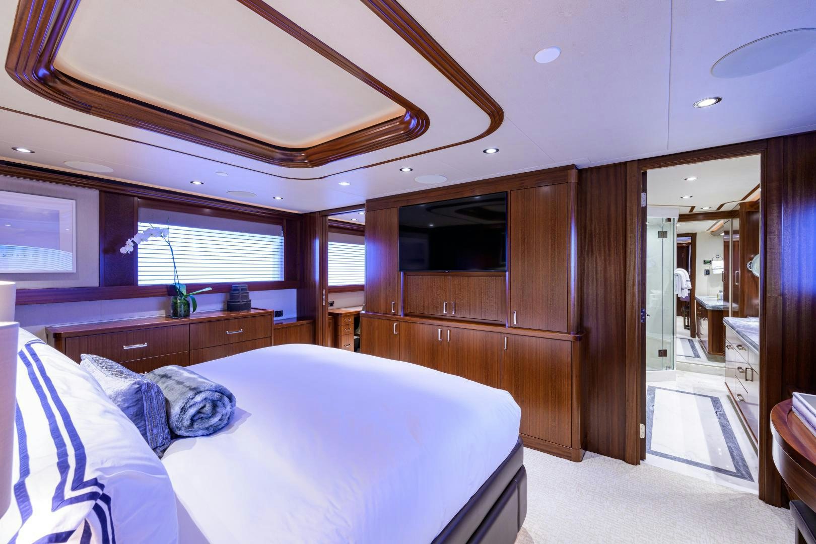 a bedroom with a bed and a wood closet aboard LADY JJ Yacht for Sale