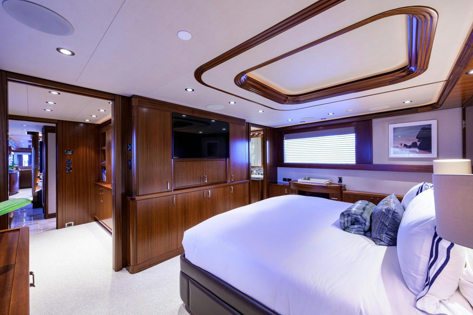 a bedroom with a bed and a wood door aboard LADY JJ Yacht for Sale
