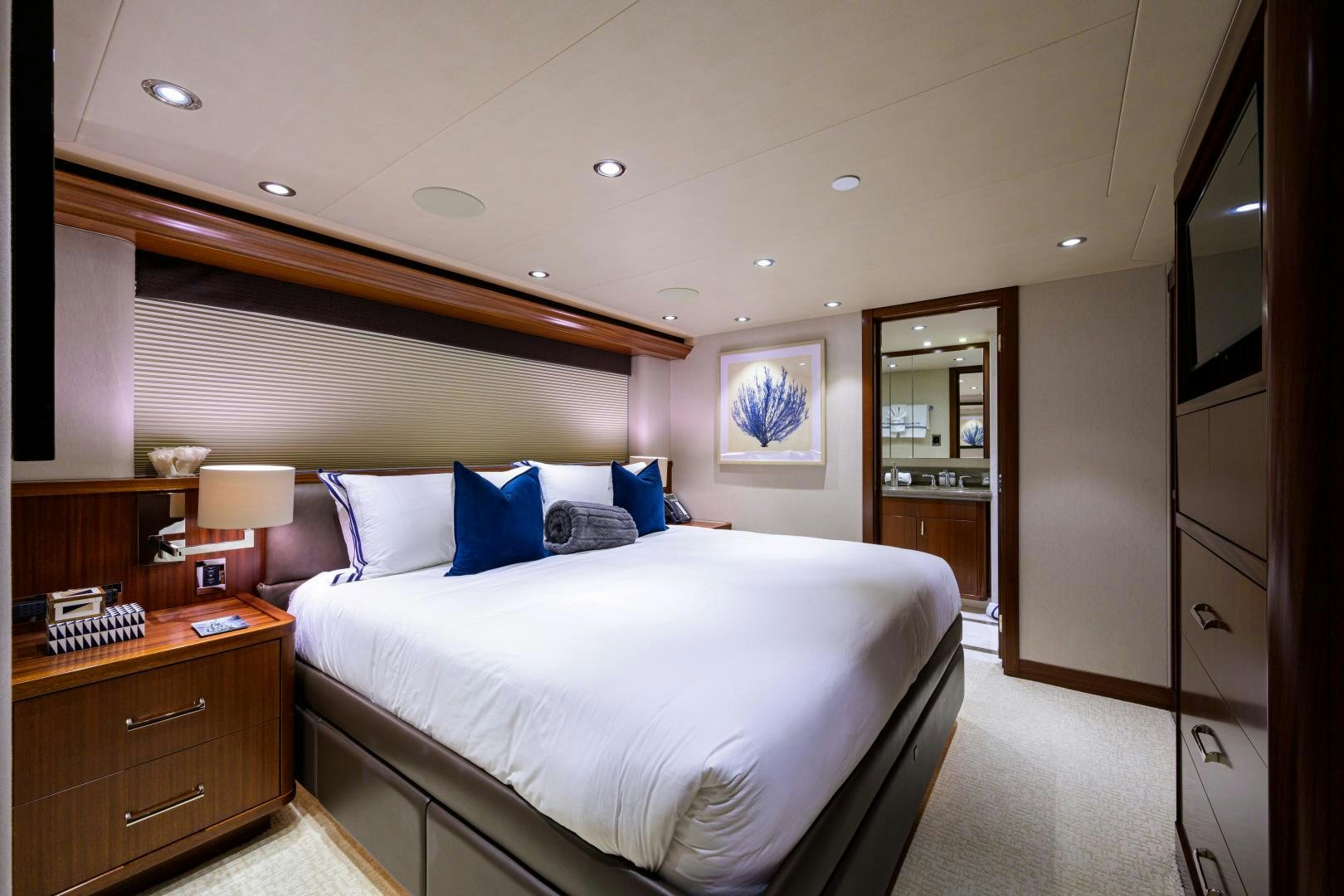 a bedroom with a bed and a desk aboard LADY JJ Yacht for Sale