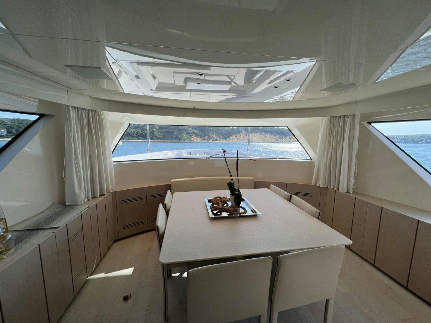 a room with a table and chairs aboard Twenty One Yacht for Sale