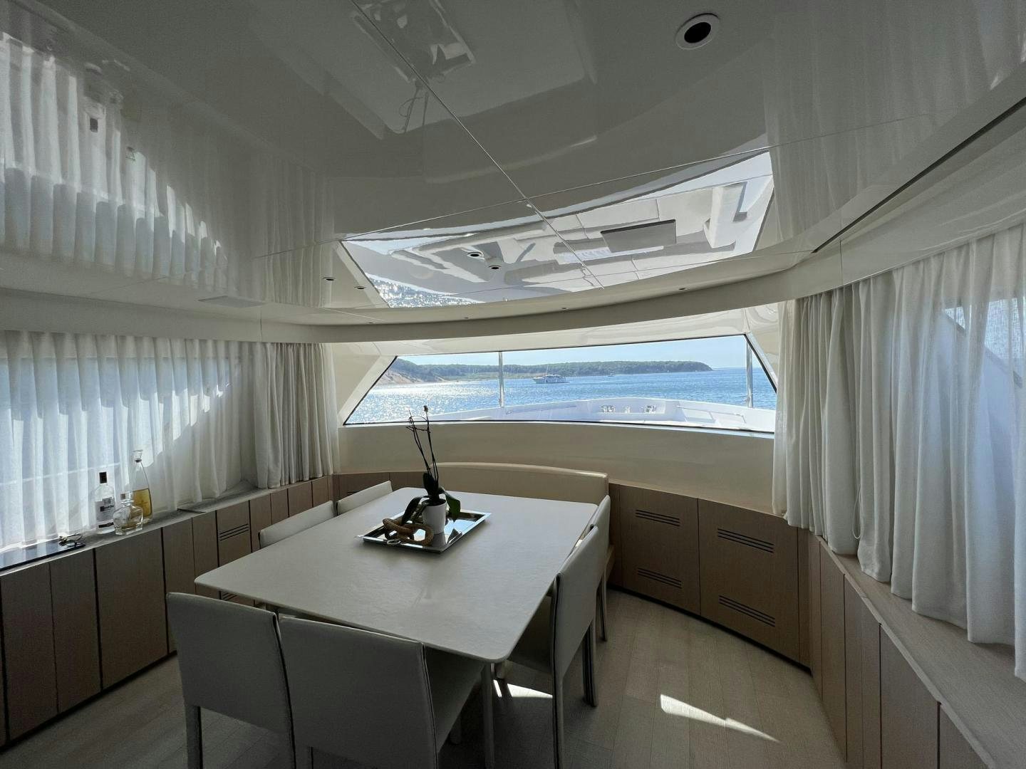 a room with a table and chairs aboard Twenty One Yacht for Sale
