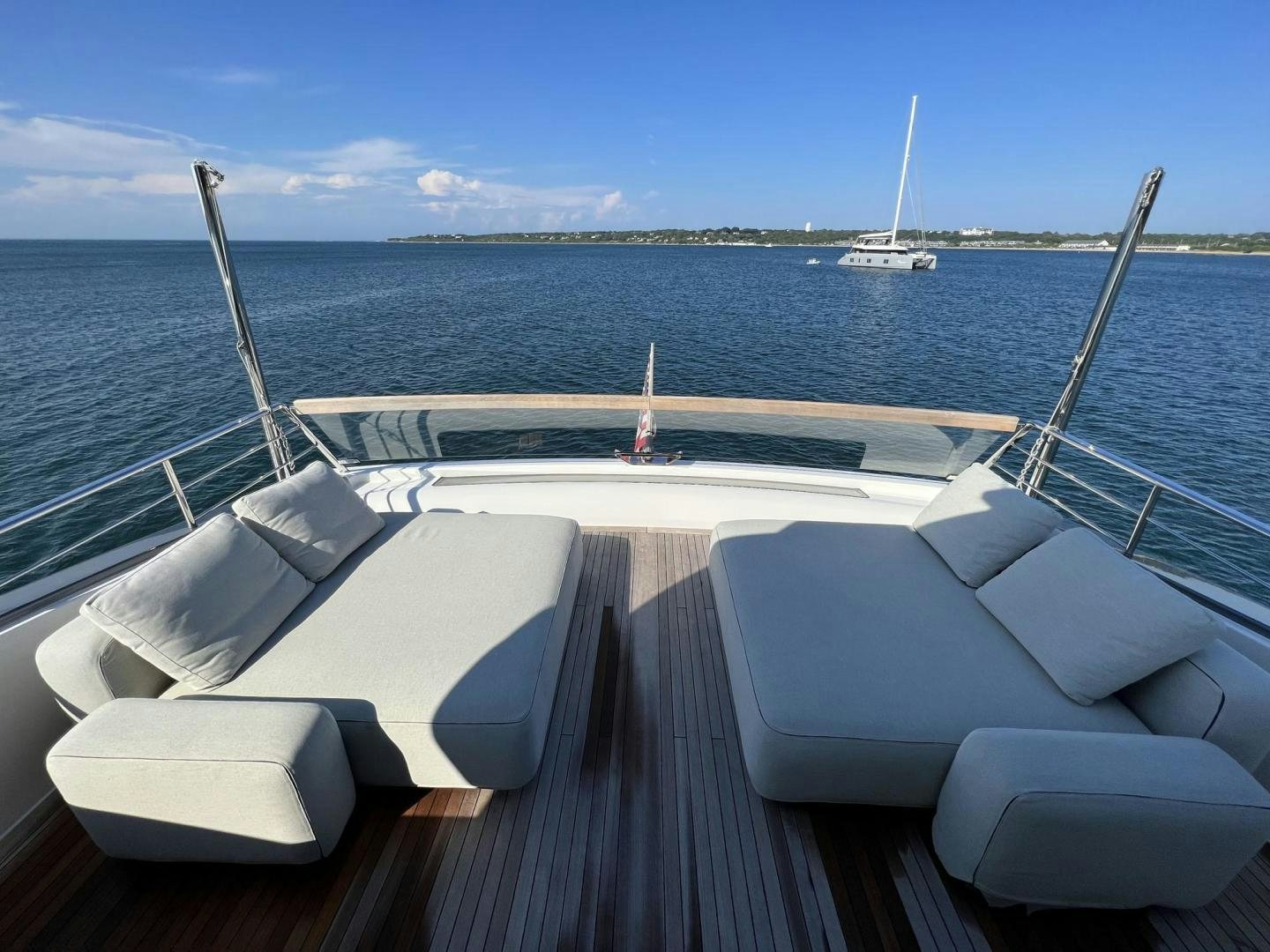 a deck with a view of the ocean and boats on it aboard Twenty One Yacht for Sale