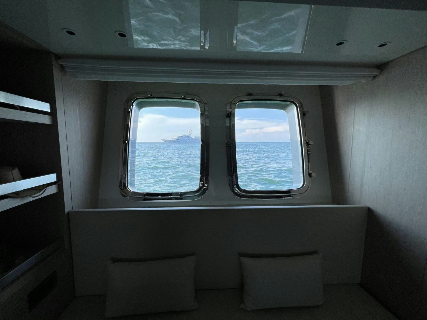 a room with a couch and a window aboard Twenty One Yacht for Sale