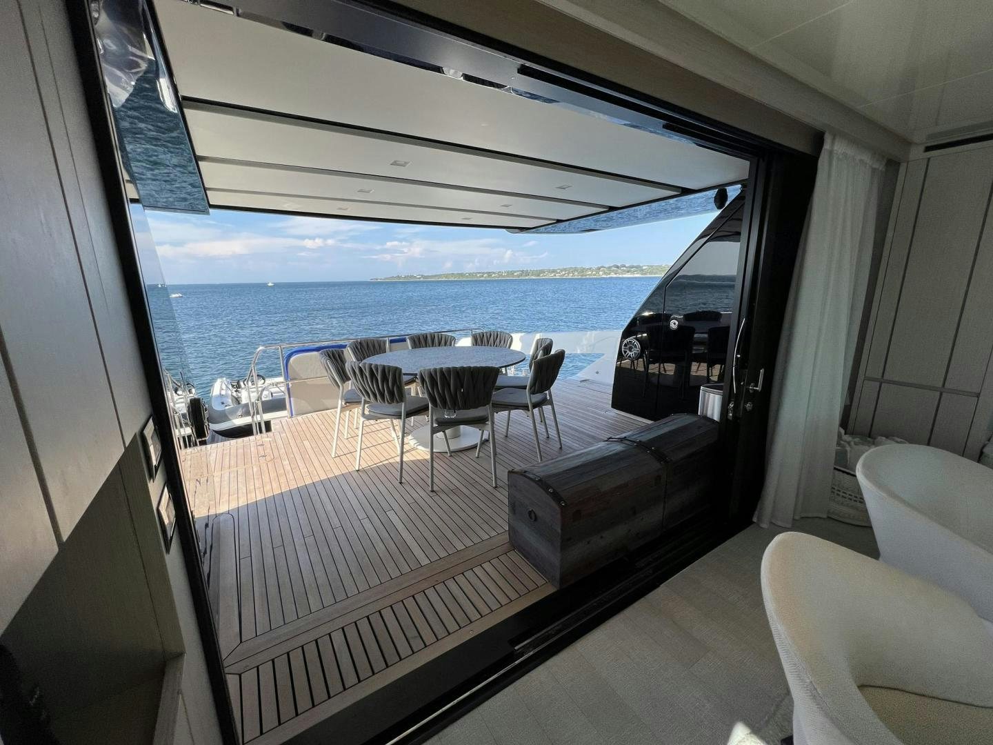 a room with a large window and a view of the ocean aboard Twenty One Yacht for Sale