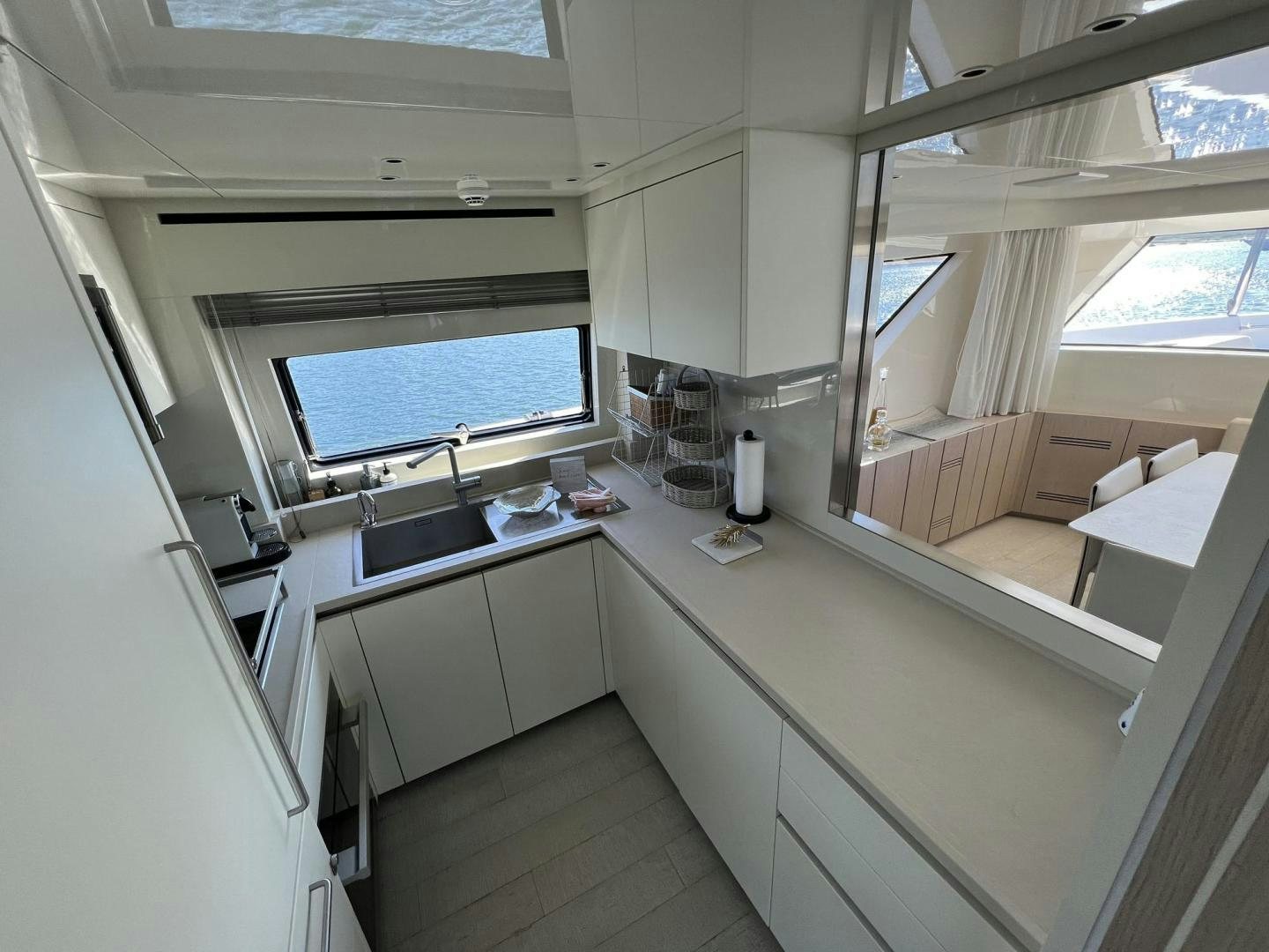 a kitchen with a window aboard Twenty One Yacht for Sale