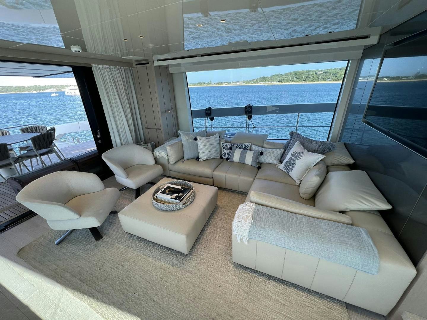 a living room with a large window aboard Twenty One Yacht for Sale