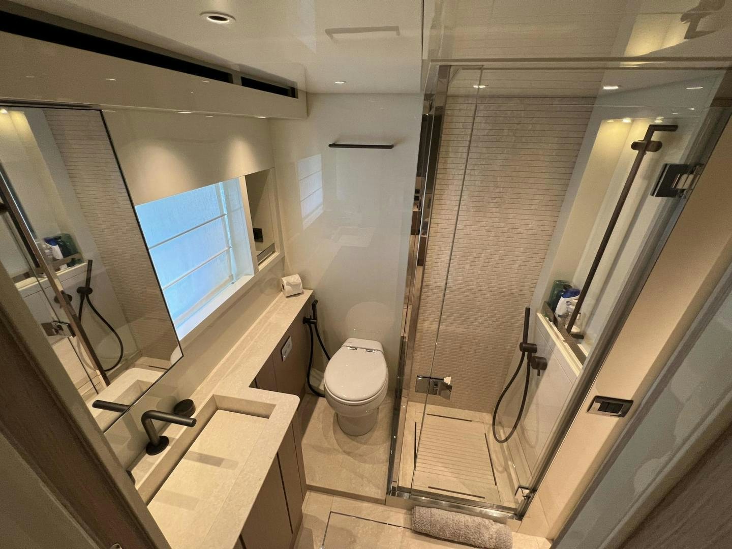 a bathroom with a glass shower aboard Twenty One Yacht for Sale