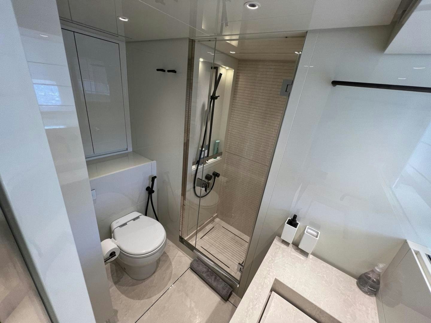 a bathroom with a glass shower aboard Twenty One Yacht for Sale