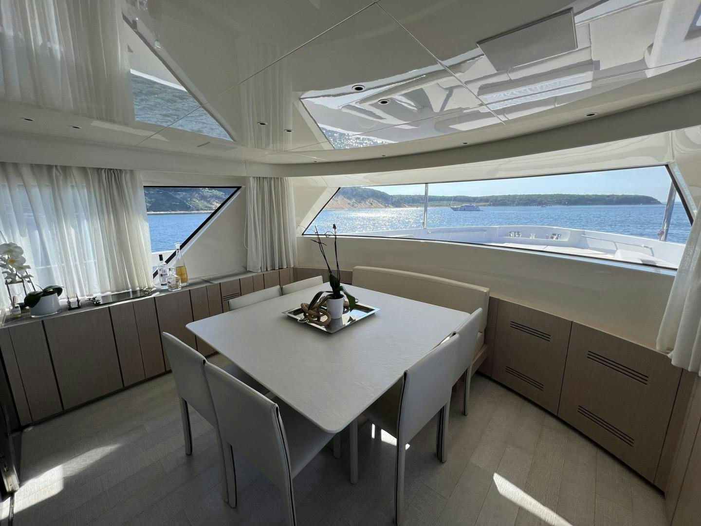 a room with a table and chairs aboard Twenty One Yacht for Sale