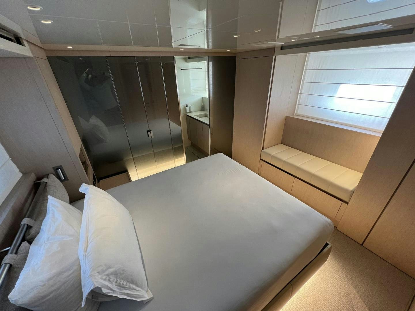 a room with a bed and a window aboard Twenty One Yacht for Sale