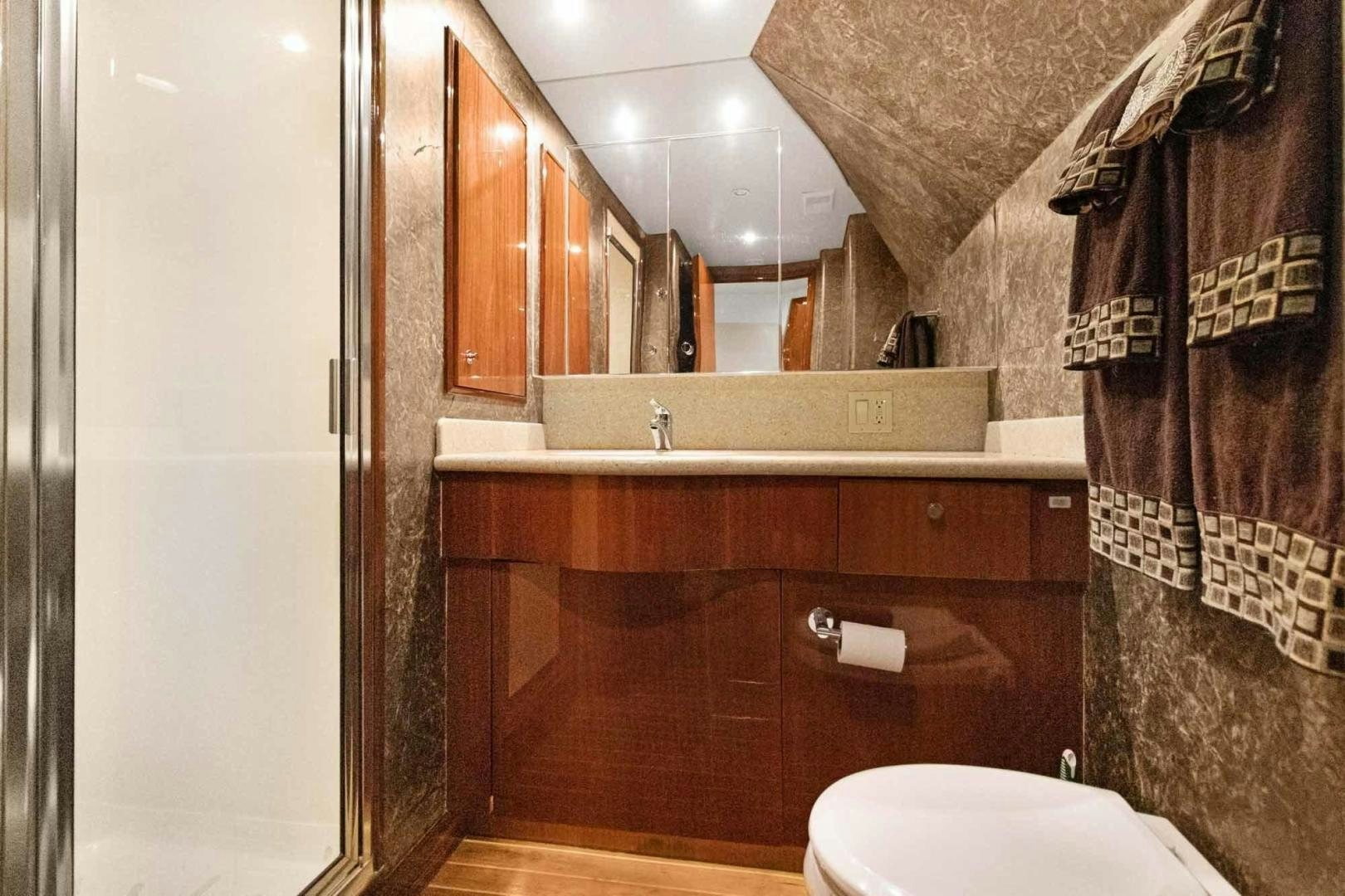 a bathroom with a toilet and a sink aboard SEMPER FI Yacht for Sale