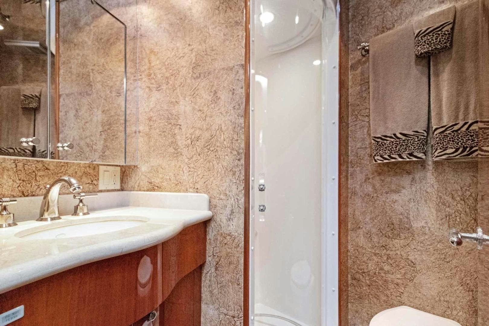 a bathroom with a shower and sink aboard SEMPER FI Yacht for Sale