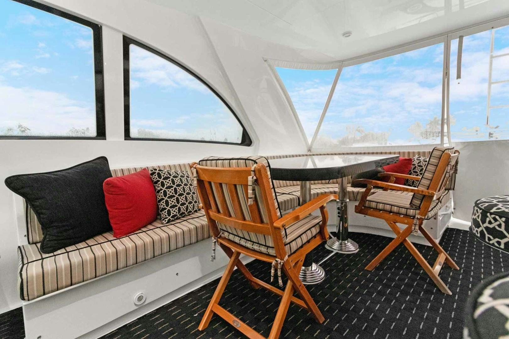 a room with a couch and a table and chairs aboard SEMPER FI Yacht for Sale