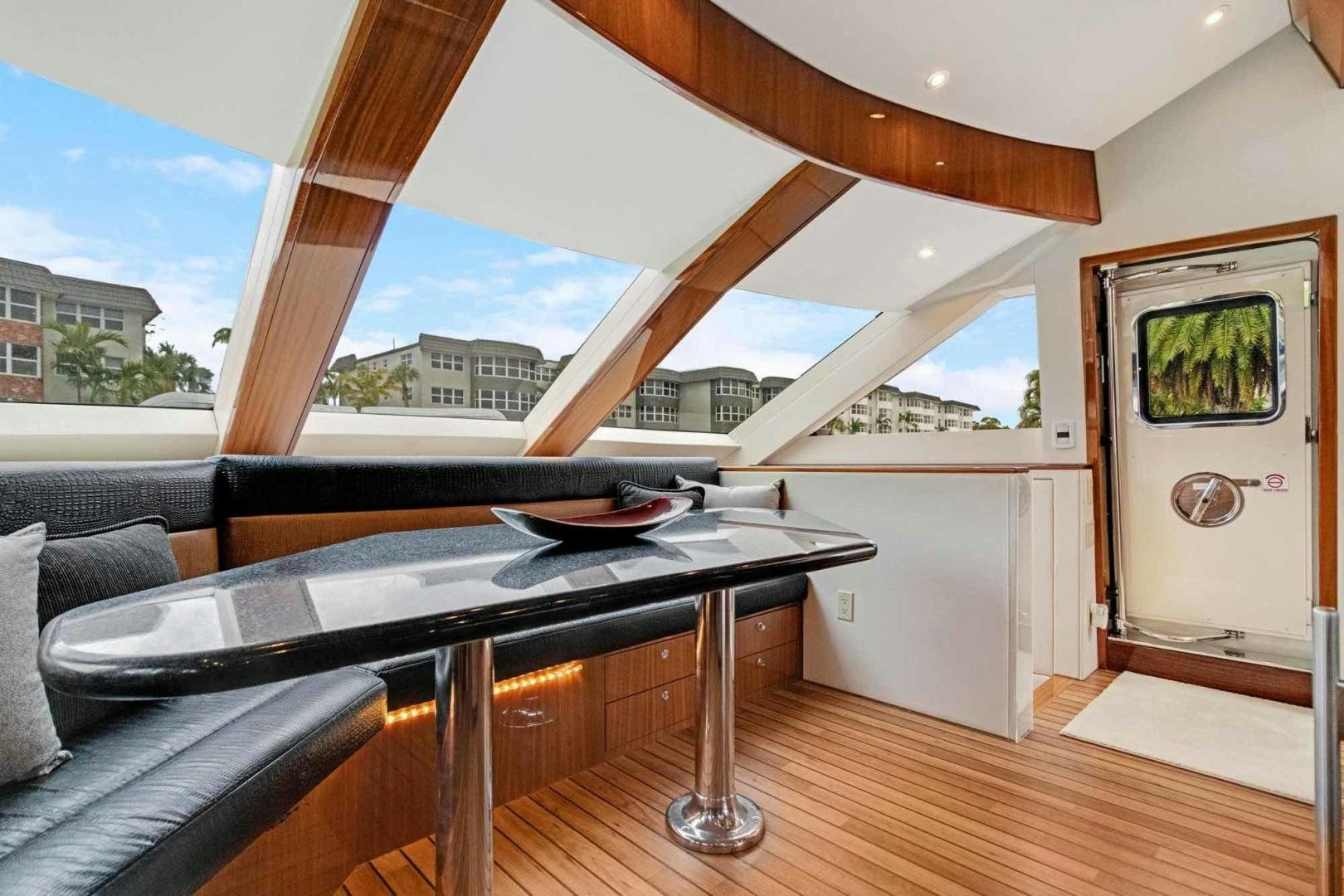 a living room with a large window aboard SEMPER FI Yacht for Sale