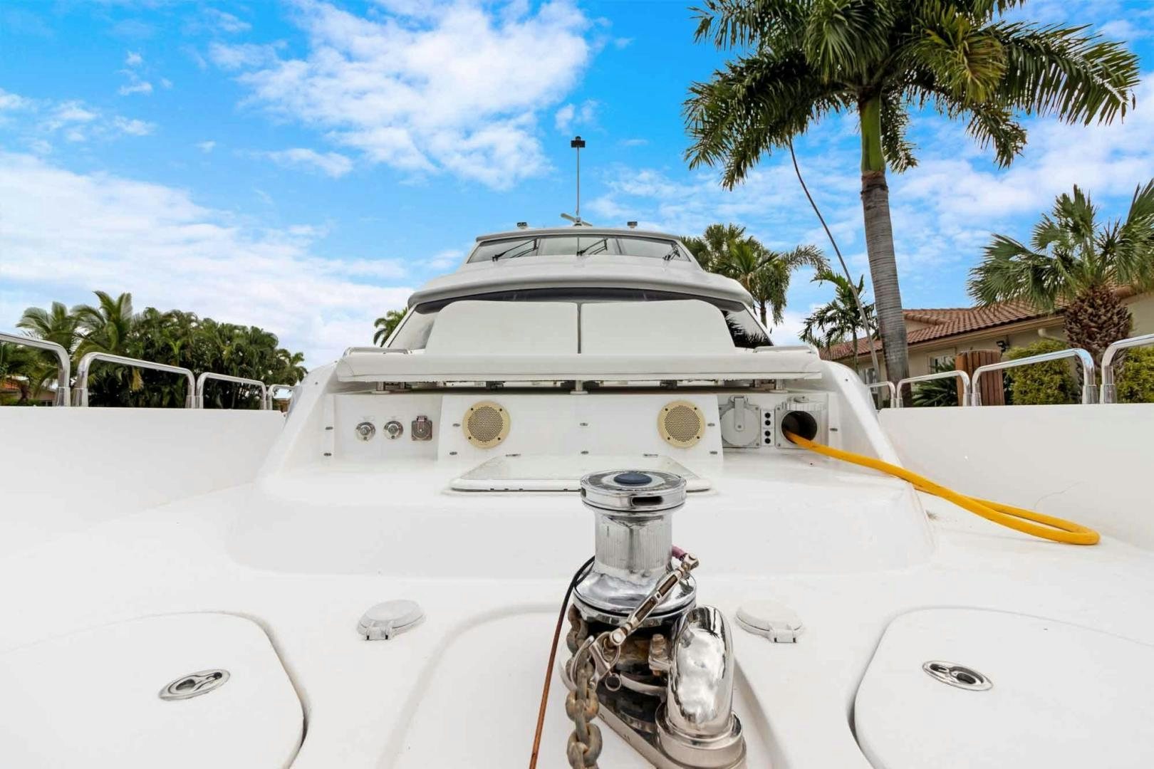 a white boat with a black and yellow stripe on the front aboard SEMPER FI Yacht for Sale