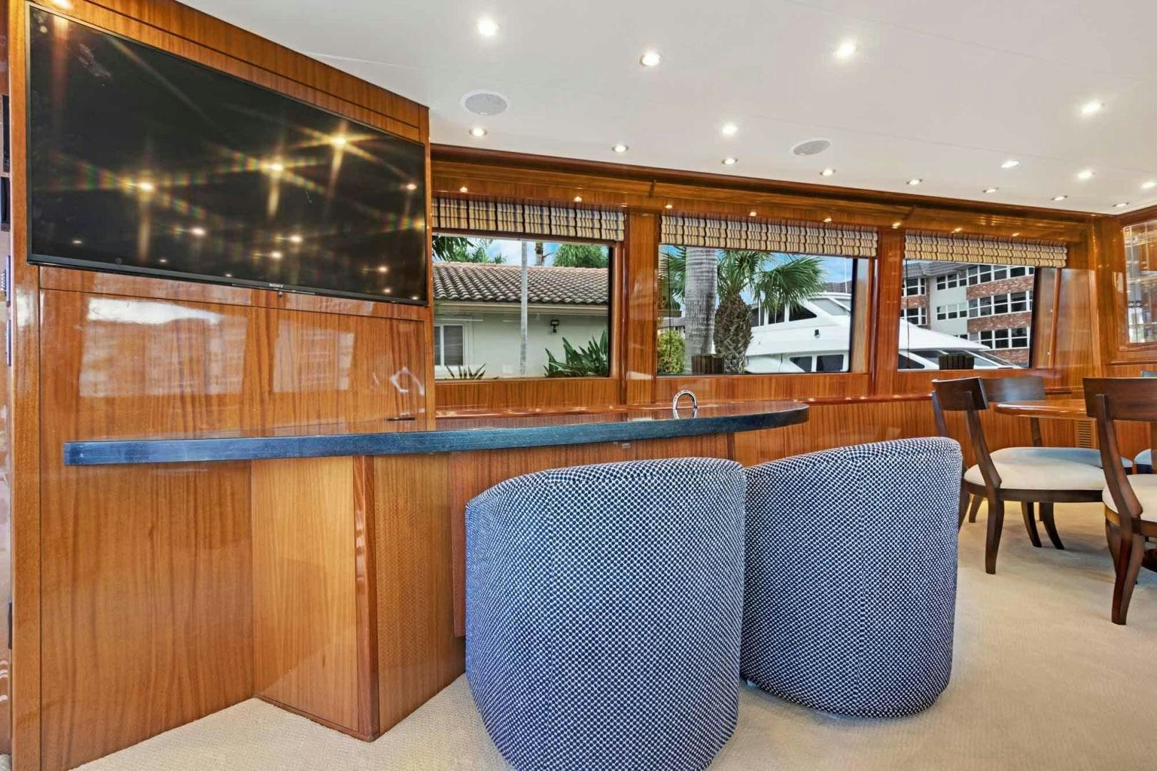 a room with a couch and a tv aboard SEMPER FI Yacht for Sale