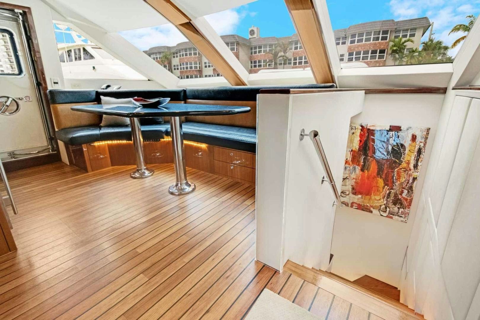 a table and chairs on a deck aboard SEMPER FI Yacht for Sale