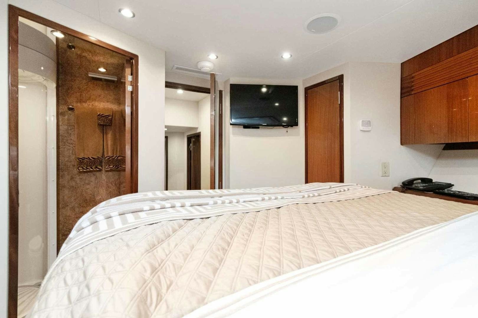 a bedroom with a large bed aboard SEMPER FI Yacht for Sale