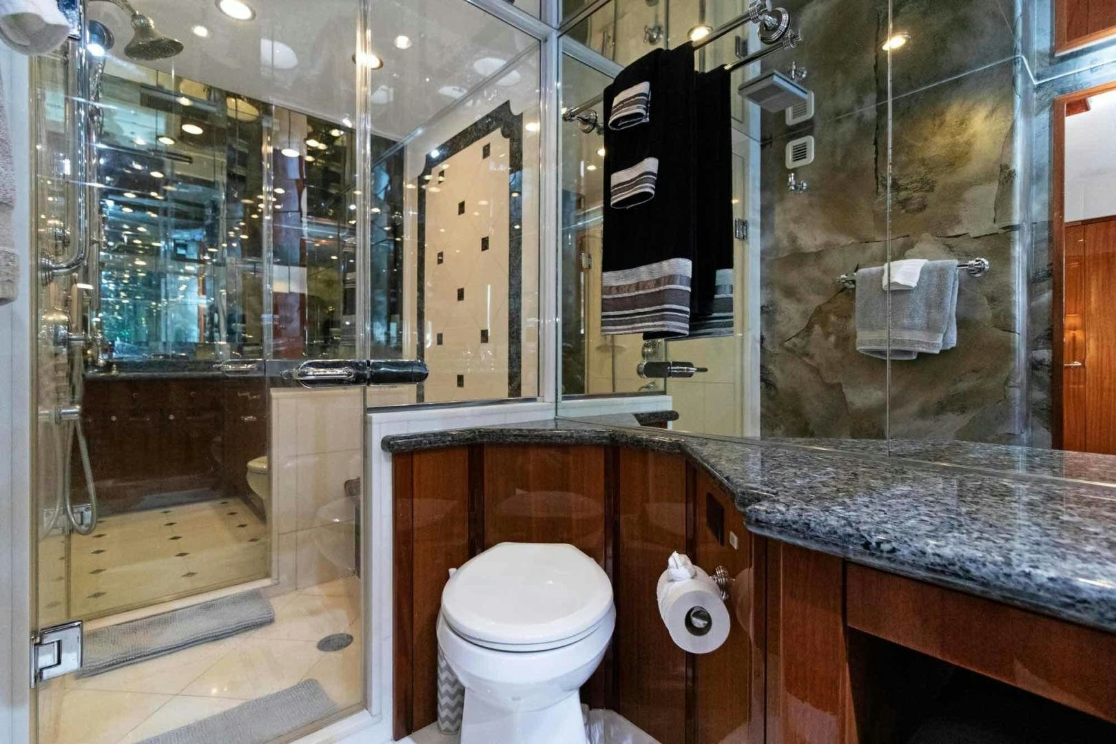 a bathroom with a glass shower aboard SEMPER FI Yacht for Sale