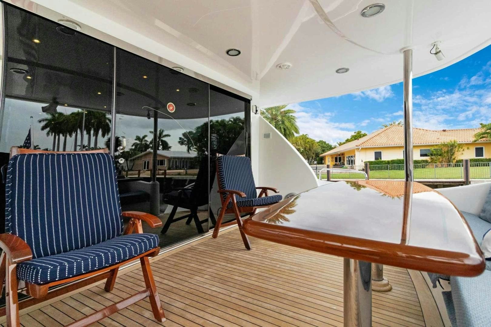 a table and chairs on a deck aboard SEMPER FI Yacht for Sale