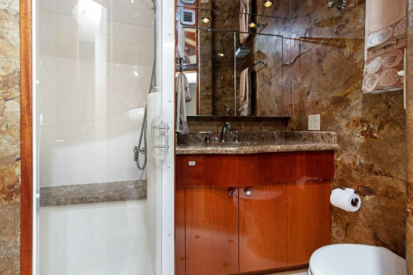 a bathroom with a glass shower aboard SEMPER FI Yacht for Sale