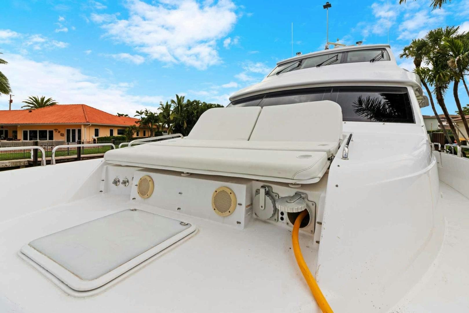 a white boat on a dock aboard SEMPER FI Yacht for Sale