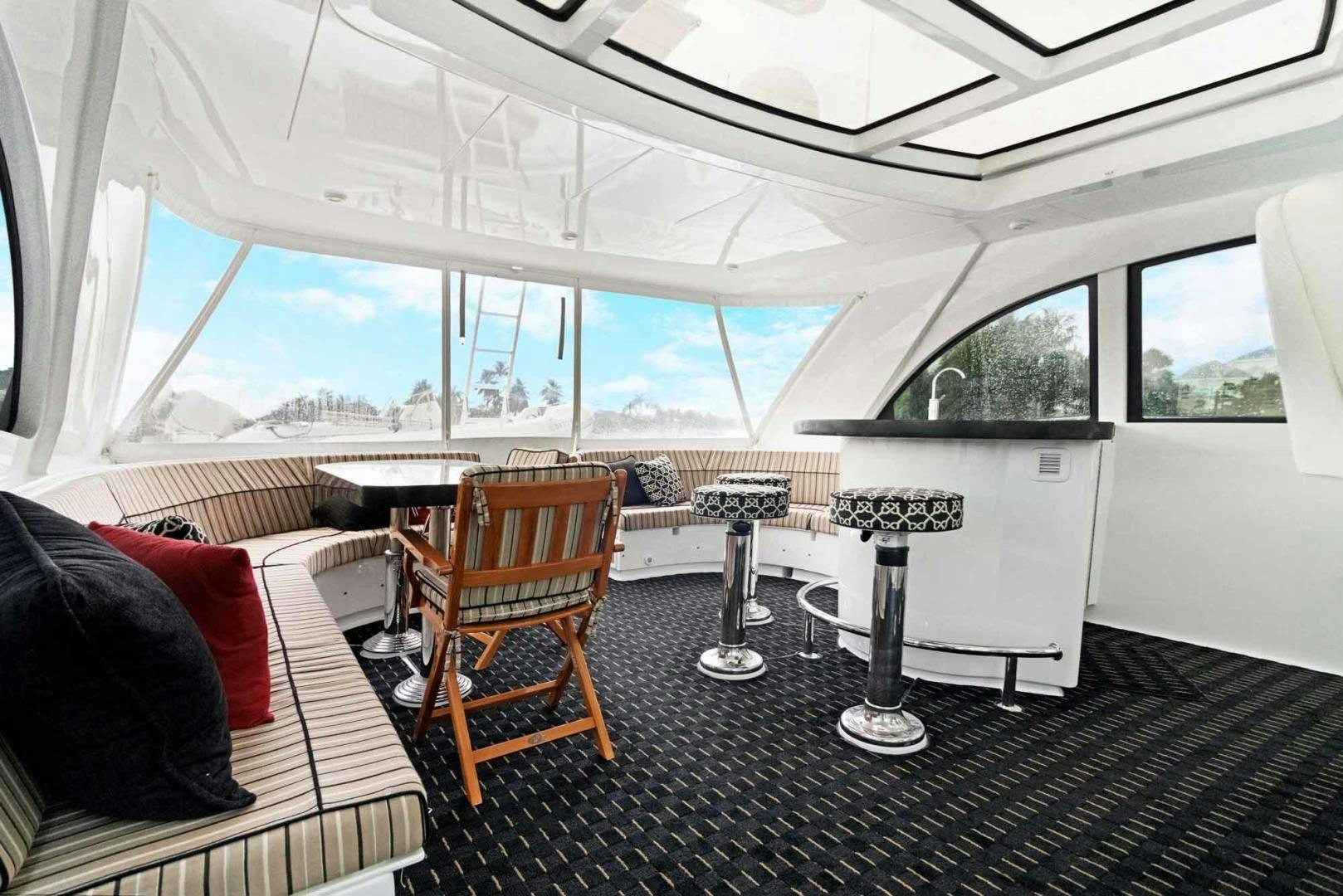 a room with a couch and a table and chairs aboard SEMPER FI Yacht for Sale