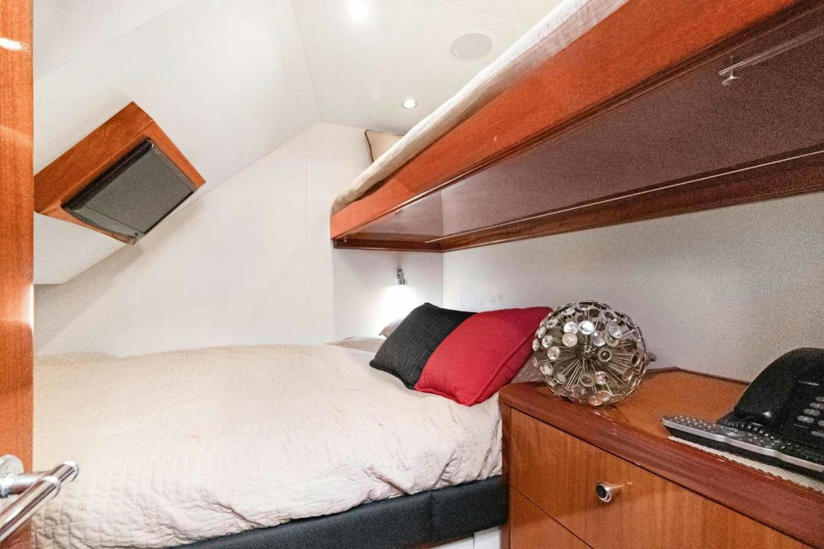 a bed with a white bed spread aboard SEMPER FI Yacht for Sale