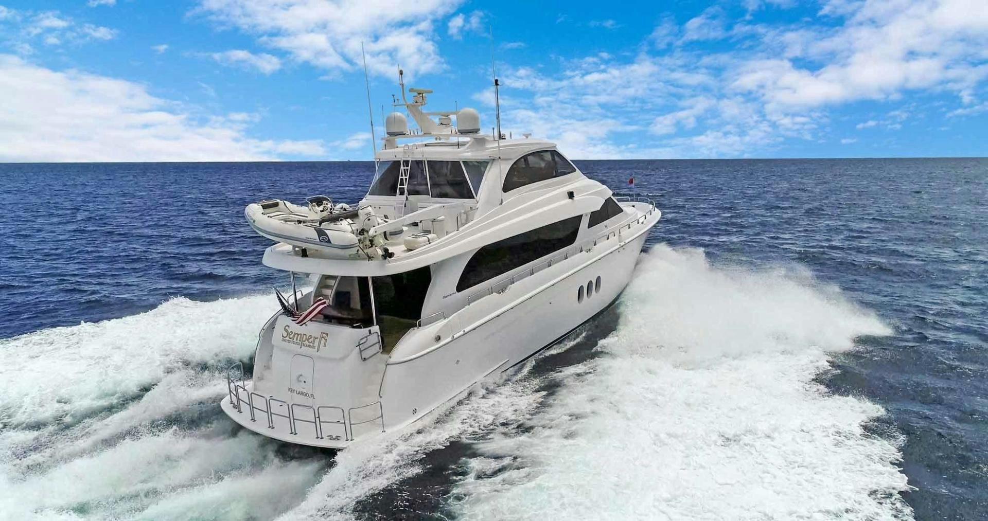 a white yacht on the water aboard SEMPER FI Yacht for Sale