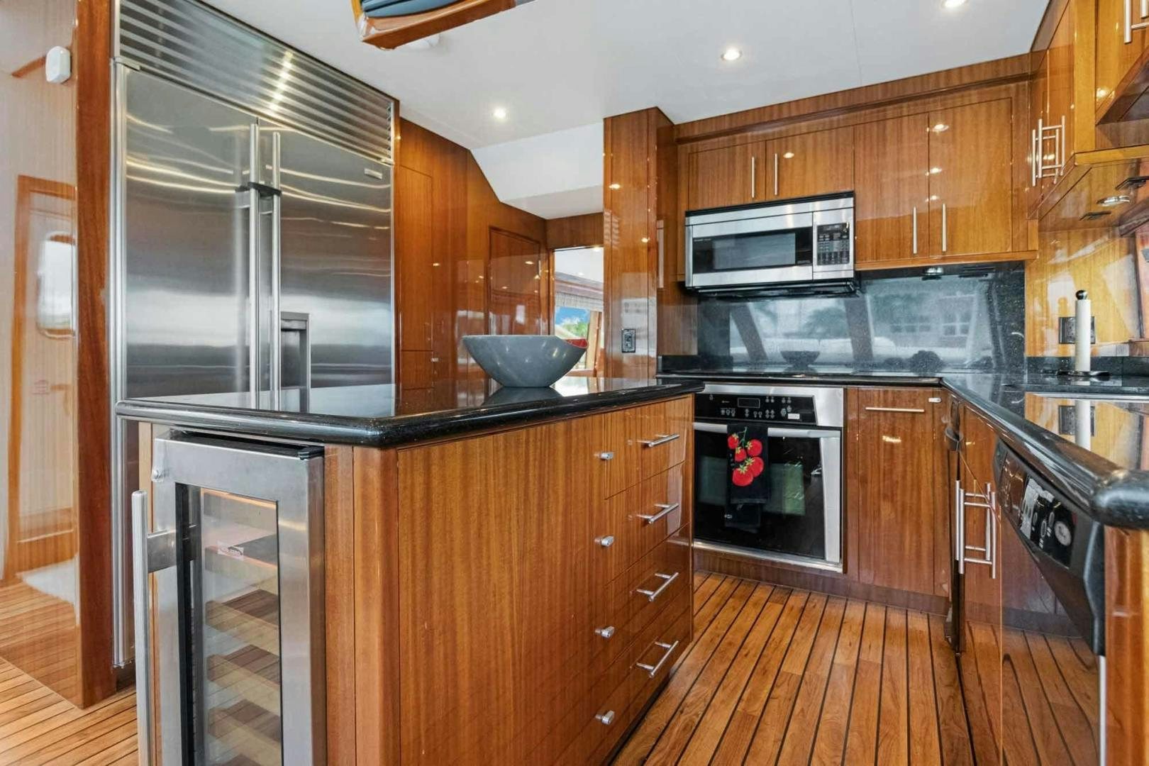 a kitchen with wooden cabinets aboard SEMPER FI Yacht for Sale
