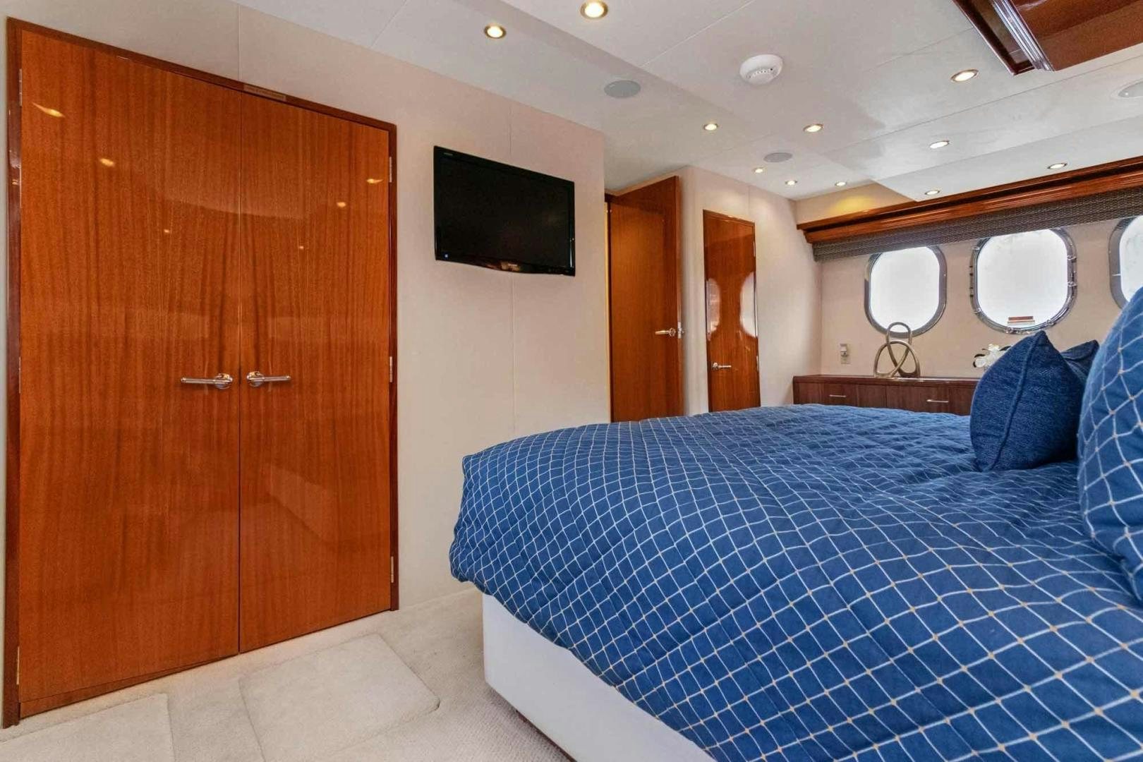 a bed and a television in a room aboard SEMPER FI Yacht for Sale