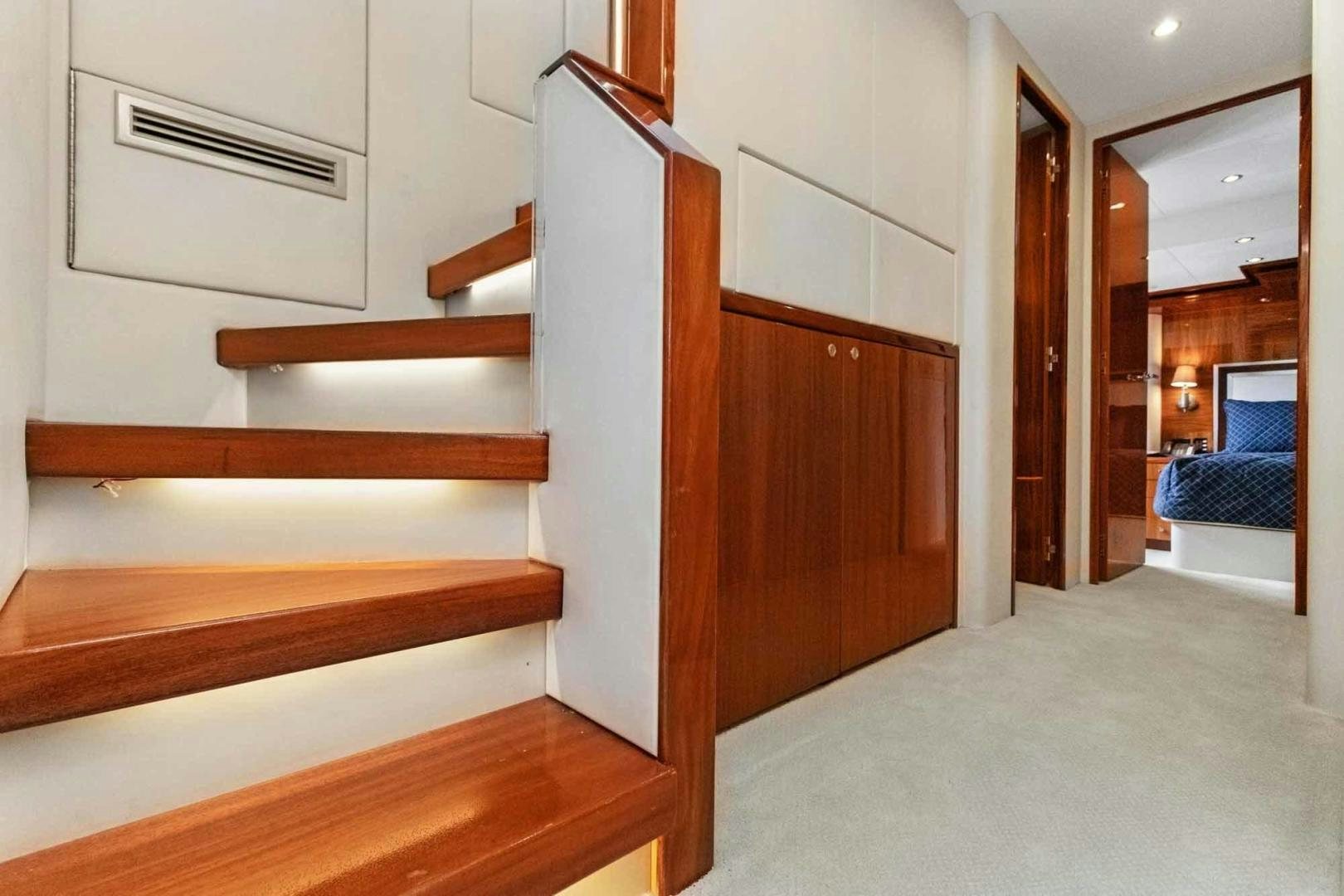 a room with wooden stairs aboard SEMPER FI Yacht for Sale