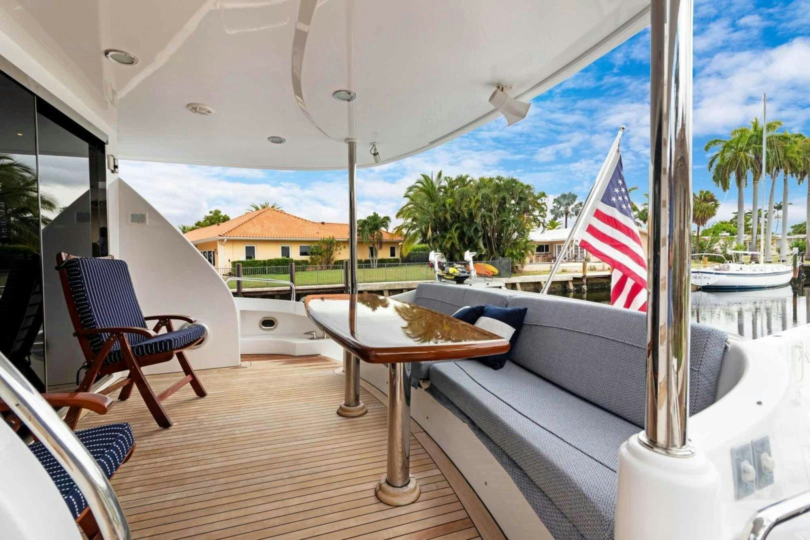 a table and chairs on a deck aboard SEMPER FI Yacht for Sale