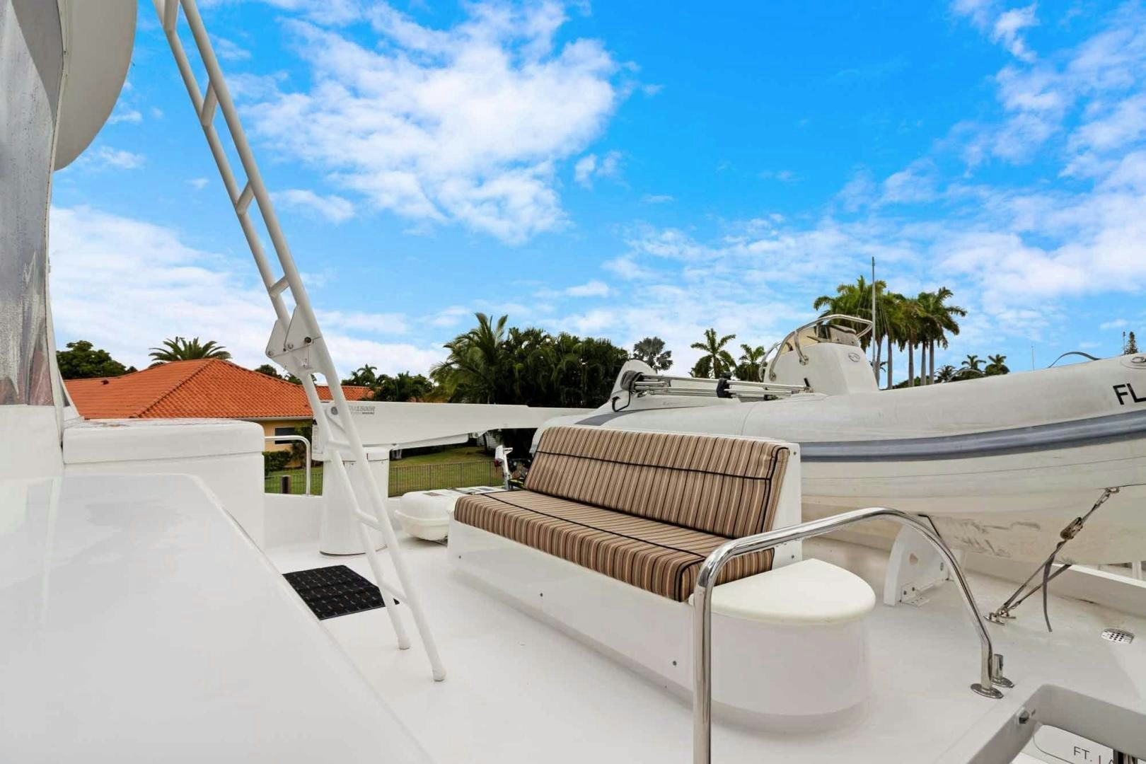 a white chair on a white deck aboard SEMPER FI Yacht for Sale