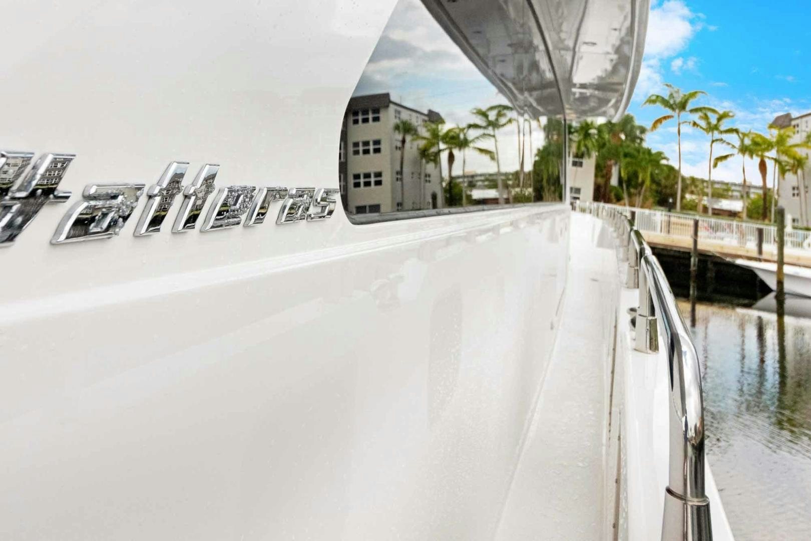 a white car parked on a street aboard SEMPER FI Yacht for Sale