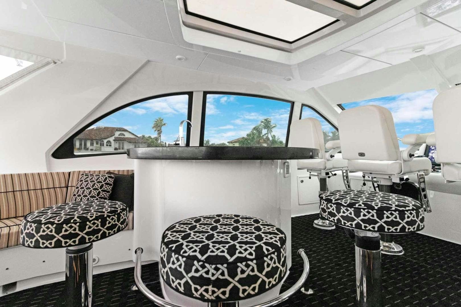 inside of a white car aboard SEMPER FI Yacht for Sale