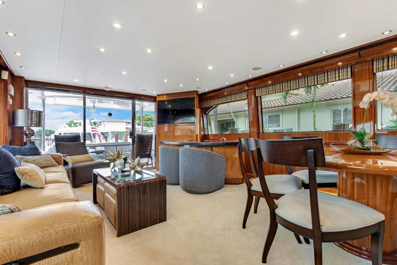 a living room with a large glass window aboard SEMPER FI Yacht for Sale