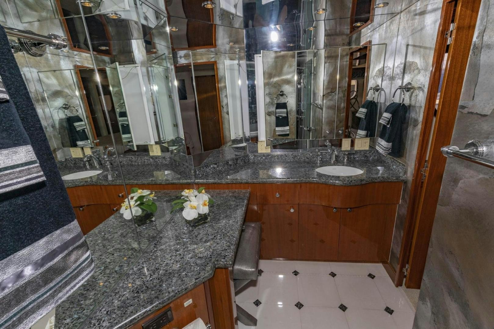 a bathroom with marble counter tops aboard SEMPER FI Yacht for Sale