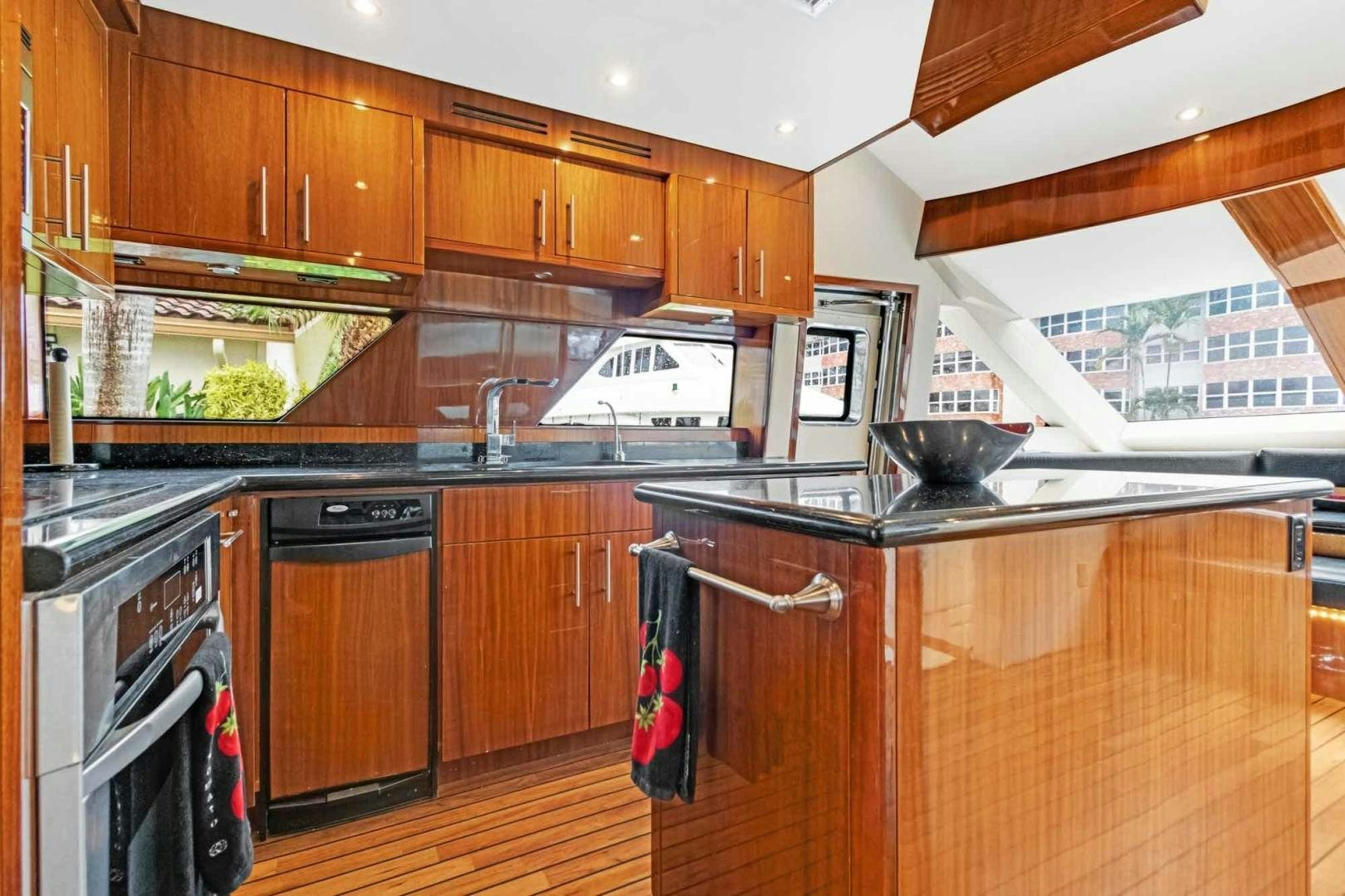 a kitchen with wooden cabinets aboard SEMPER FI Yacht for Sale
