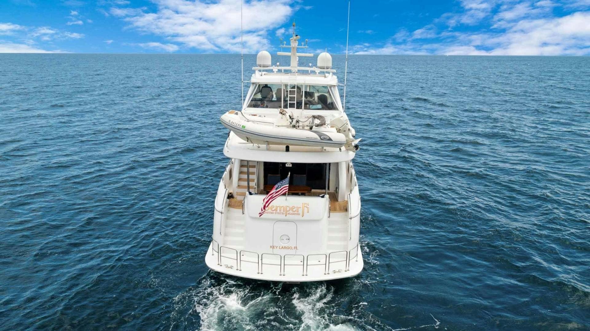 a white boat in the water aboard SEMPER FI Yacht for Sale