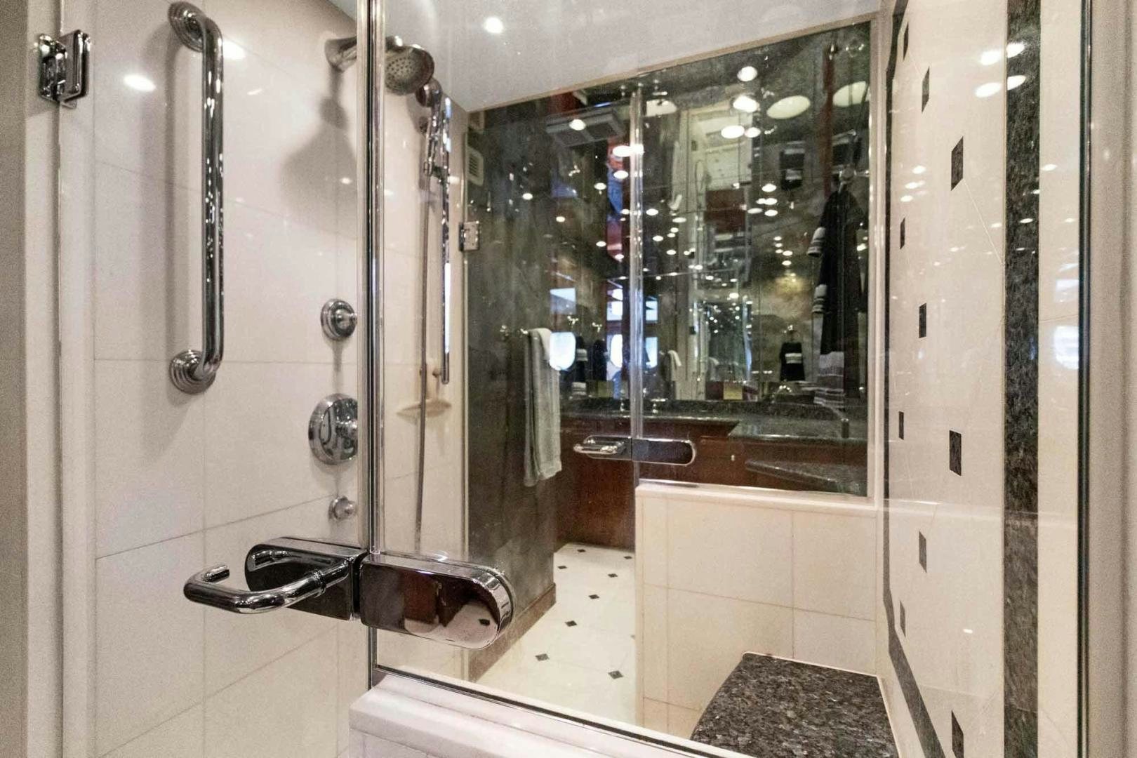 a bathroom with a glass shower aboard SEMPER FI Yacht for Sale