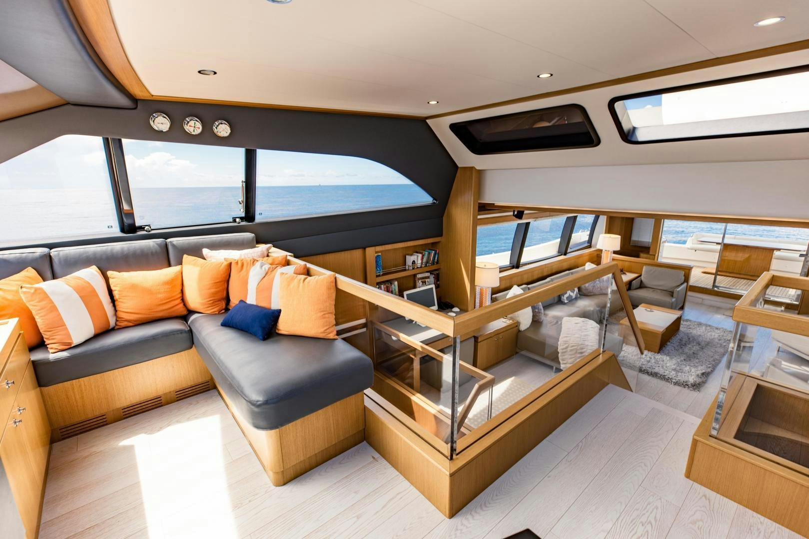 a living room with a couch and a table aboard SHE RUNS WET Yacht for Sale