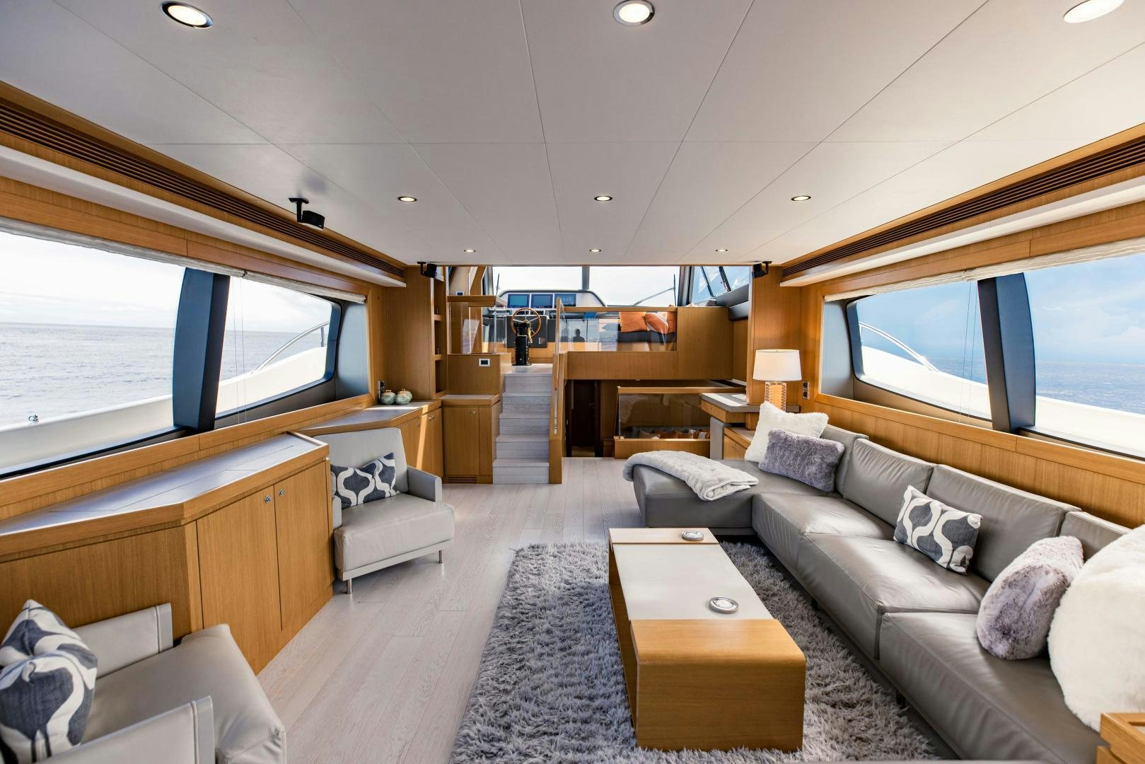 a living room with a large window aboard SHE RUNS WET Yacht for Sale