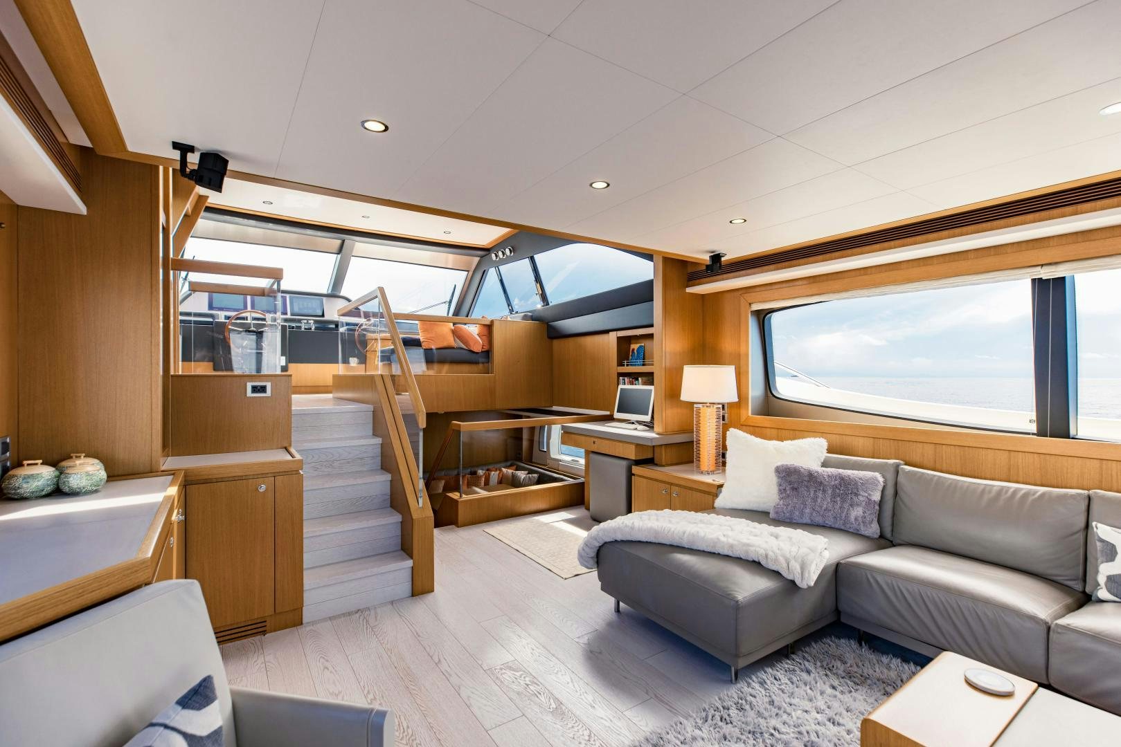 a living room with a large window aboard SHE RUNS WET Yacht for Sale