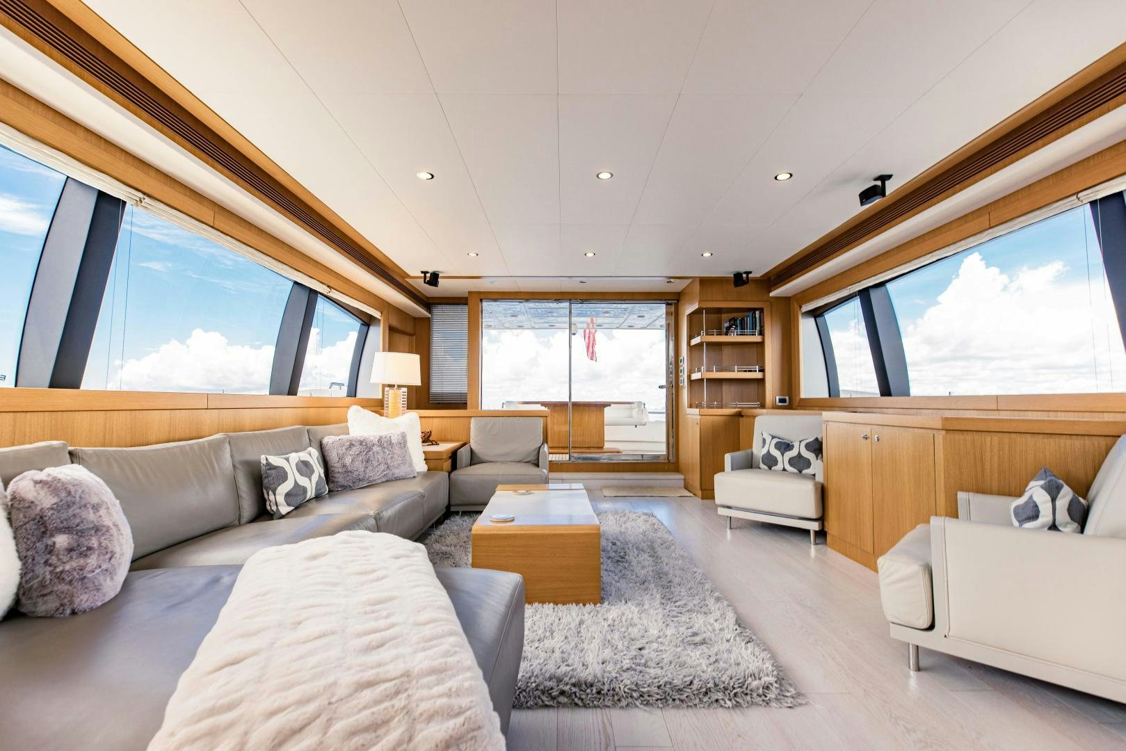 a living room with a large window aboard SHE RUNS WET Yacht for Sale