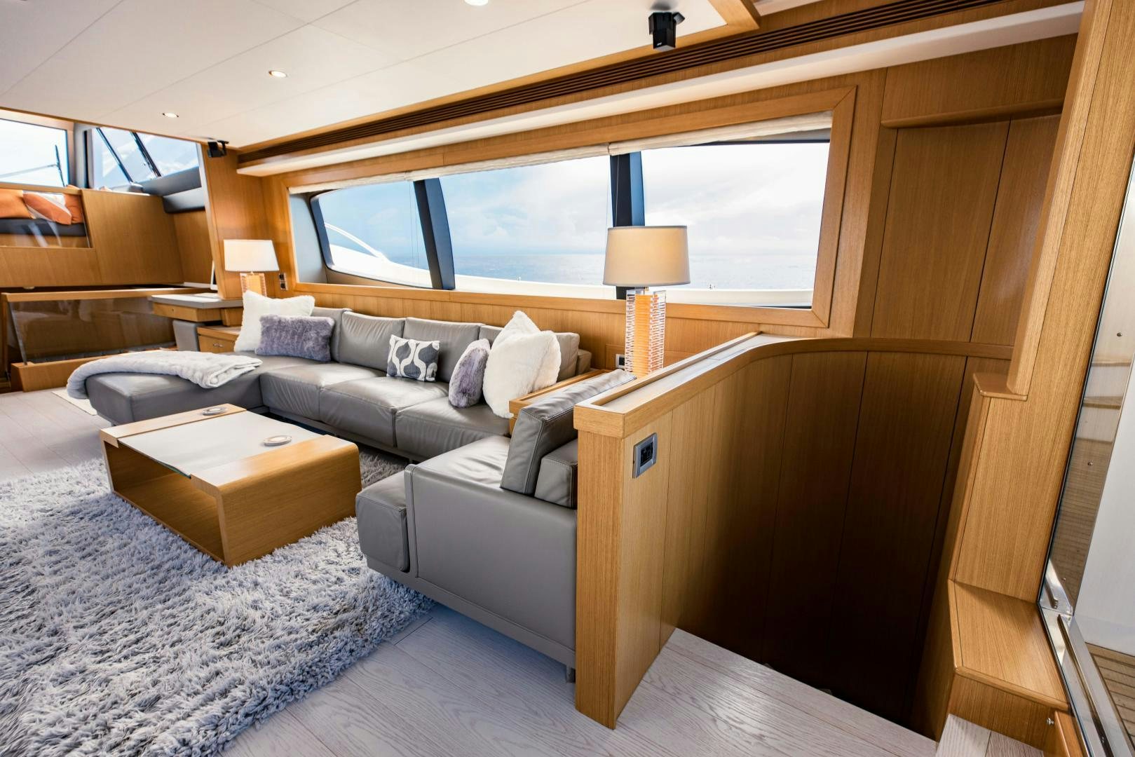 a living room with a couch and a coffee table aboard SHE RUNS WET Yacht for Sale