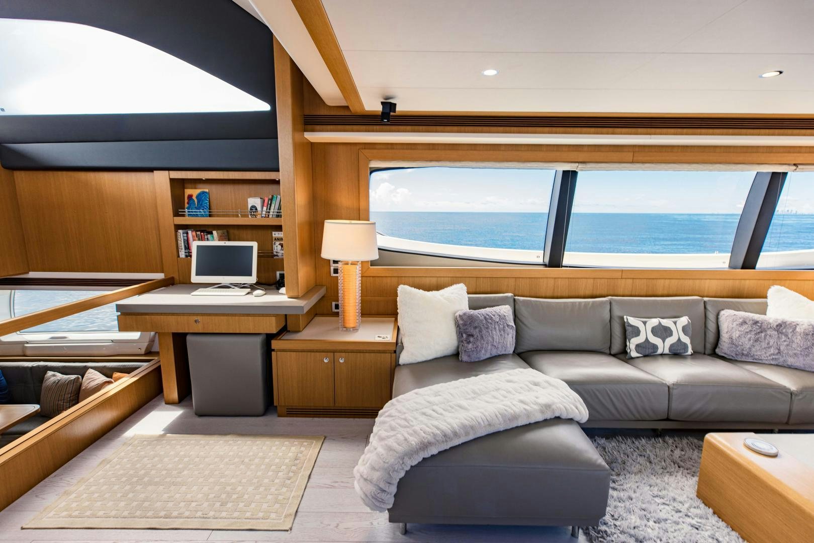 a living room with a large window aboard SHE RUNS WET Yacht for Sale