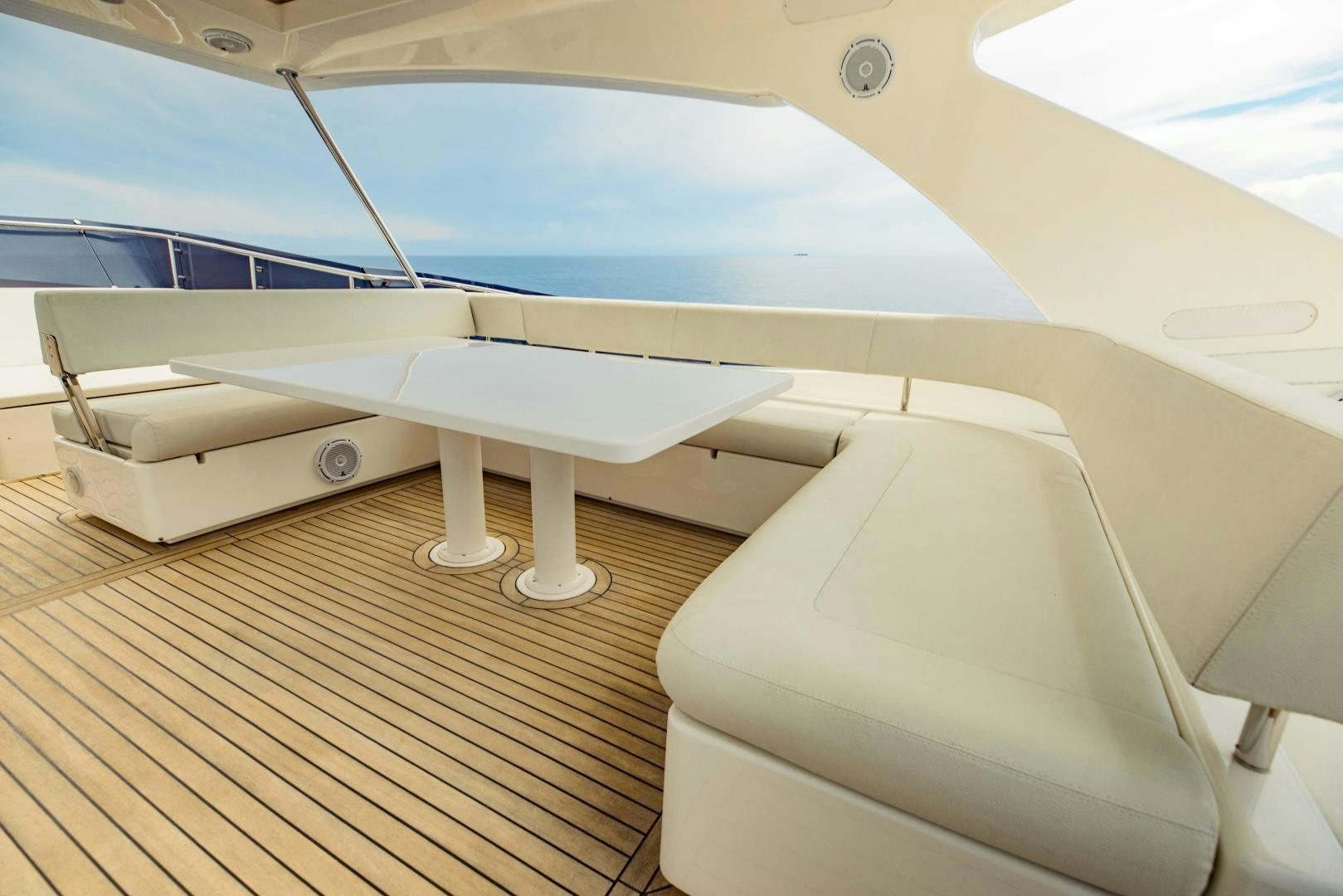 a white bed on a wooden floor aboard SHE RUNS WET Yacht for Sale