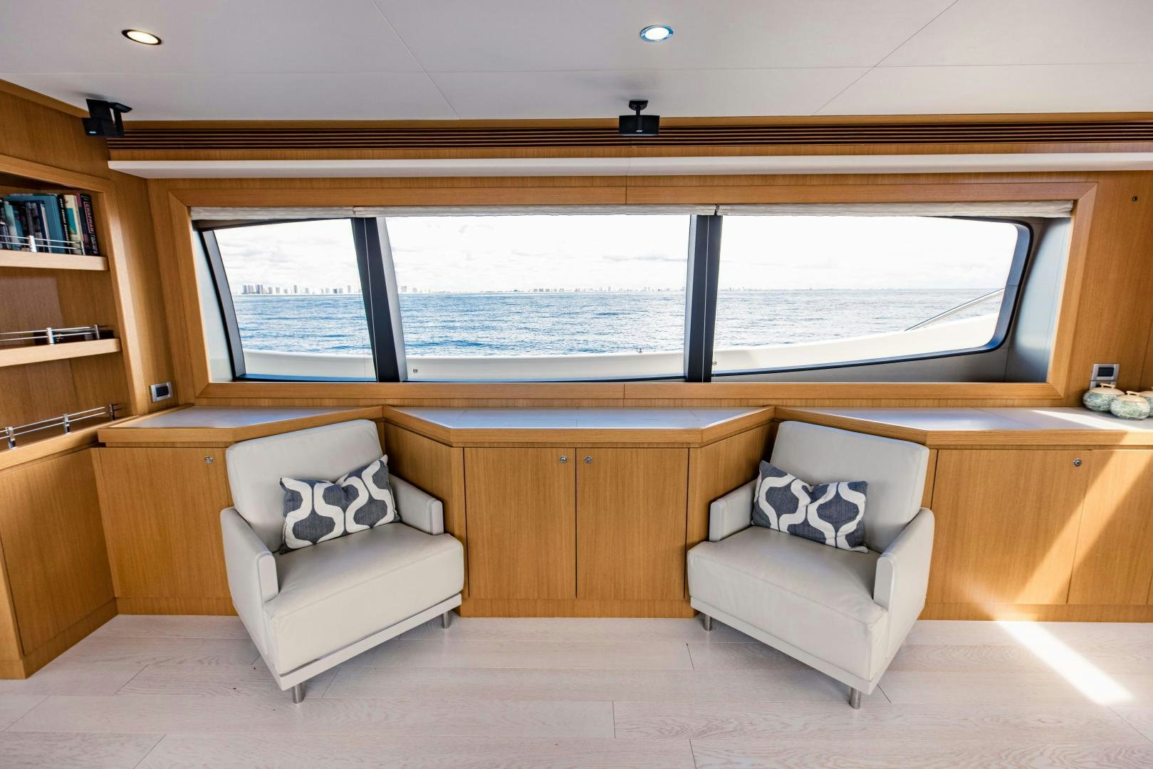 a room with a couch and a window aboard SHE RUNS WET Yacht for Sale